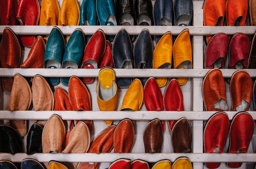 Photo by Martin Adams assorted-color shoe lot on white wooden shelf